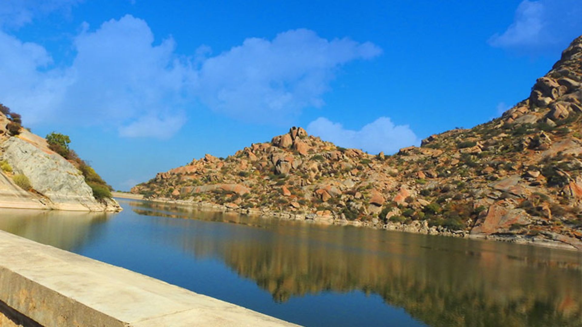 Rajasthan Tourism - Enjoy this breathtaking shot of the Jawai Dam. With the  vivid blue hues of the sky reflected on crystal clear waters and the  serenity around it, you will be