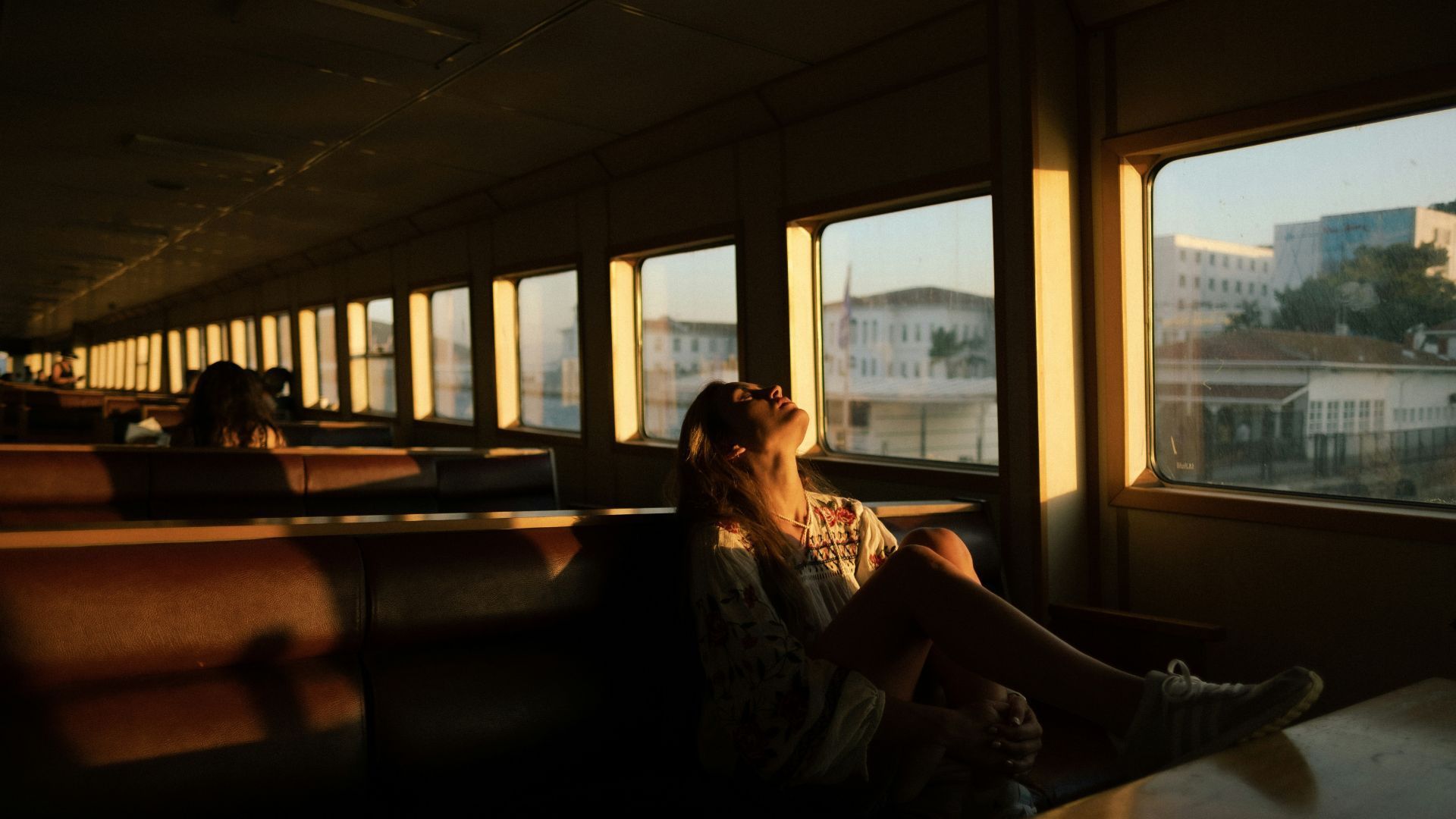 A person looking out a window at night.