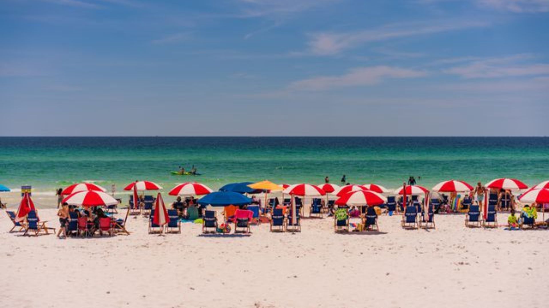 People sitting with Umbrellas at Beach