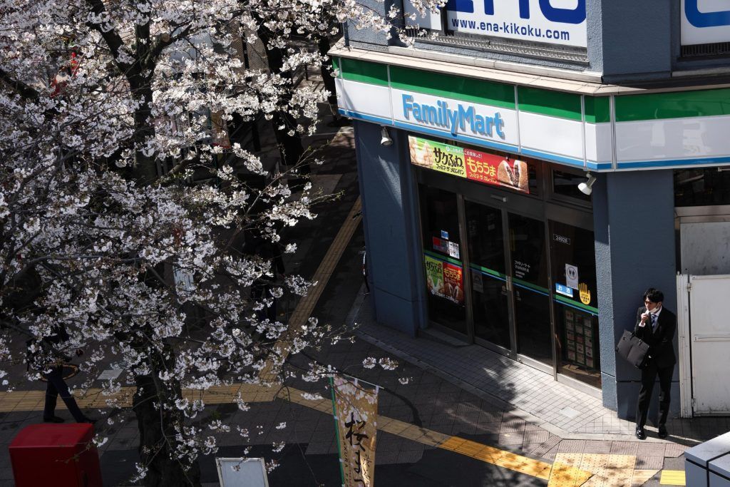 A convenience store next to a blooming Sakura in Shibuya