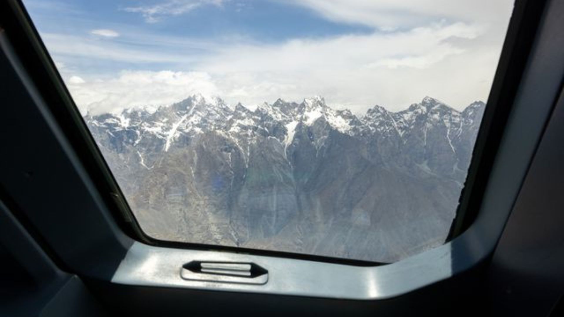 View of snow capped mountains from a plane
