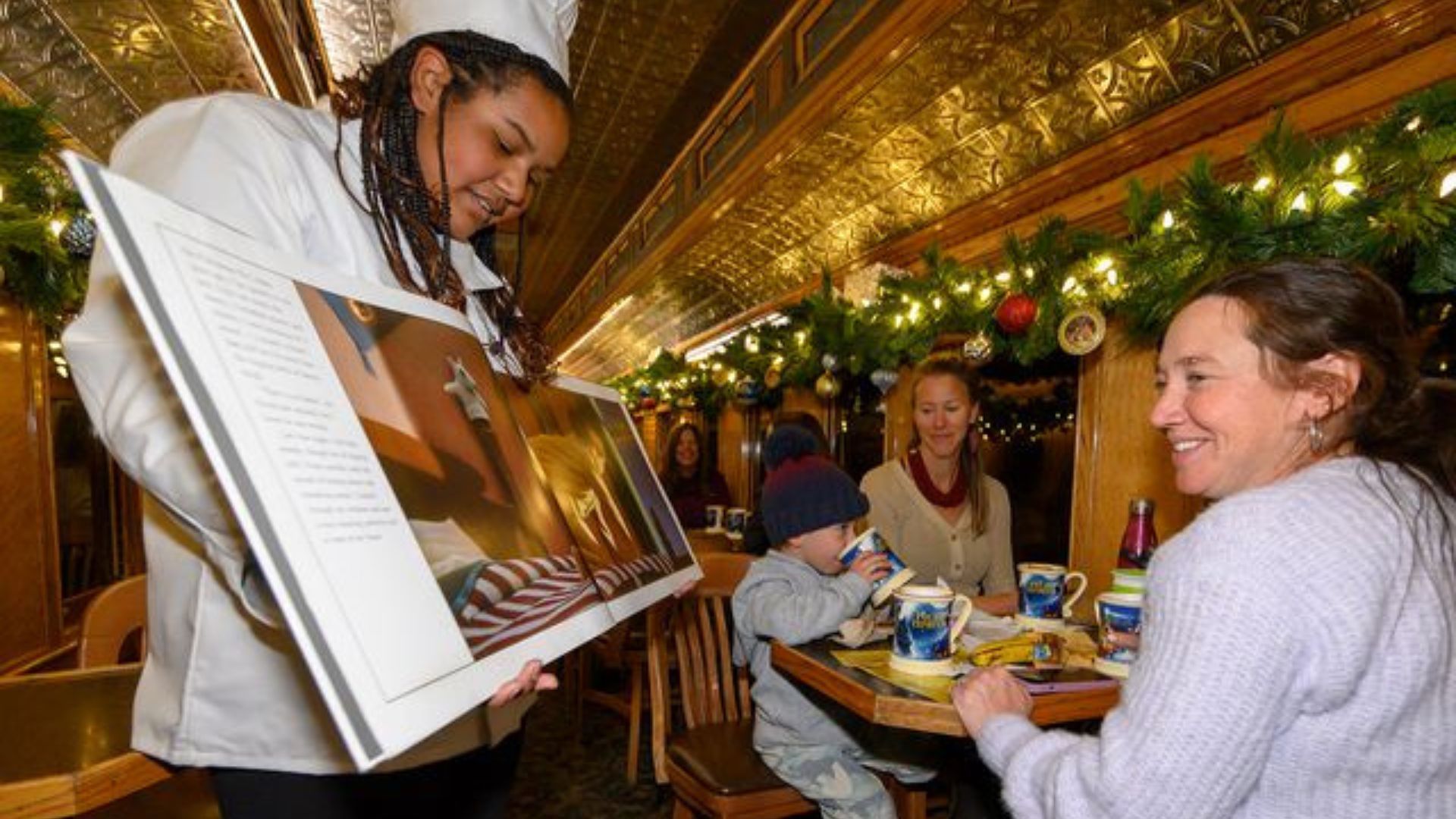 A chef on board reading from polar express book