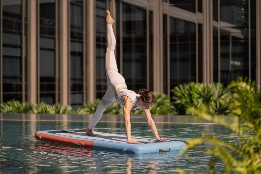 Balance breath and body with floatboard yoga at Four Seasons Bangkok at Chao Phraya River