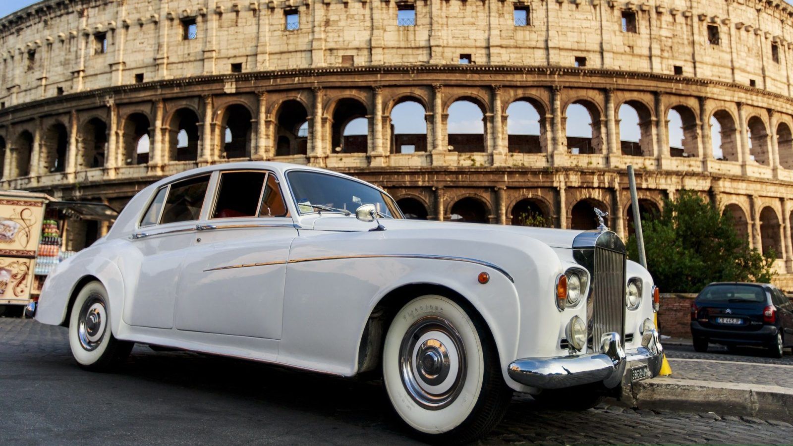 Car Rentals In Rome Renting The - Feature Rolls Royce Car In Front Of Colosseum In Rome Bgstock72 Shutterstock 1600x900